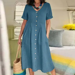 Close-up detail of blue cotton linen midi dress featuring V-neckline and button-down front