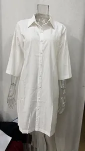 Loose white linen-cotton shirt dress featuring lapel buttons and mid-length sleeves.