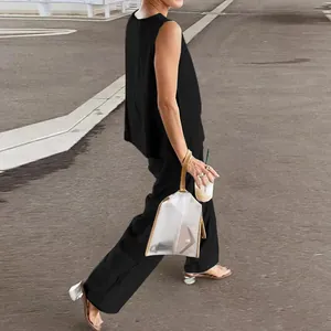 Detailed street view of a black casual sleeveless top and wide-leg trousers set