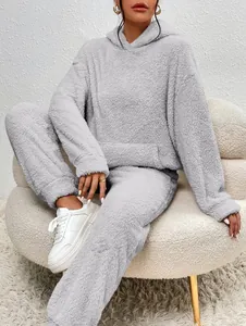 Cozy grey fuzzy fleece lounge set featuring oversized hoodie with pocket and matching pants