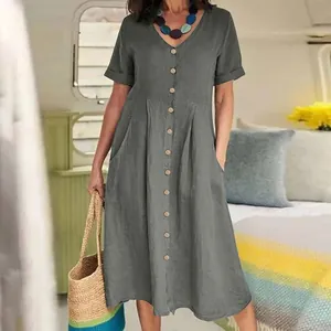 Close-up of solid grey cotton linen dress with V-neck and button details