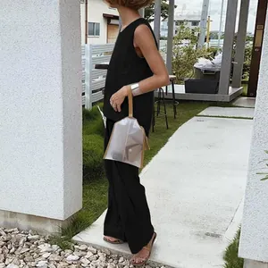 Outdoor shot of casual black sleeveless top and wide-leg pants set for women.