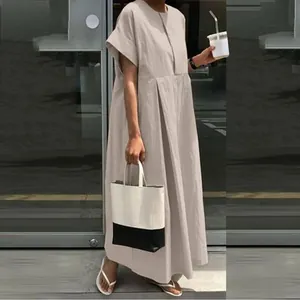 Large size loose cotton linen maxi dress in beige shown in a casual outdoor setting