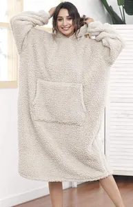 Model wearing oversized sherpa hooded wearable blanket in cream color