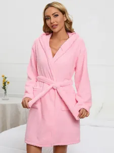 Detailed view of a soft pink plush hooded bathrobe featuring a tie-waist and side pockets