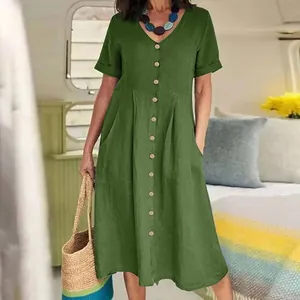 Detailed view of a casual green cotton linen button-down midi dress with pockets