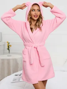 Detail of cozy pink fleece hooded bathrobe featuring cute animal ears and adjustable belt