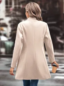 Back view of a slim fit beige woolen coat for women in a stylish urban outdoor setting.