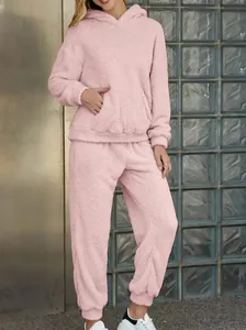 Cozy light pink fuzzy fleece two-piece lounge set with hooded sweatshirt and pants