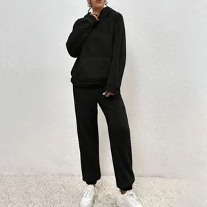 Close-up of a cozy black two-piece fleece hoodie and sweatpants set for women
