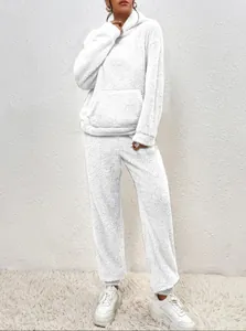 Detail view of a cozy white fuzzy fleece loungewear set with hoodie and pocket pants