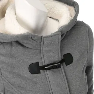 Detail of a gray hooded jacket showing toggle closure and soft white faux shearling lining.