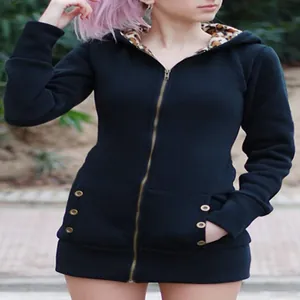 Detailed view of women's black zip-up hoodie featuring a bold leopard print hood lining
