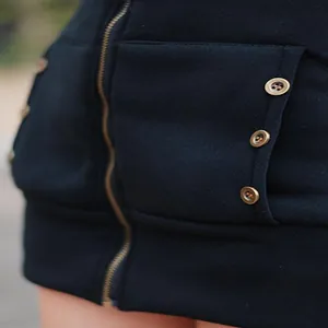 Detailed view of heavy black fleece hoodie with vintage bronze buttons and zipper closure.