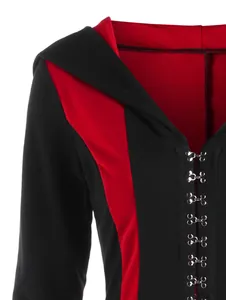 Close-up of hooded jacket showing red and black color blocking and metal hook closure
