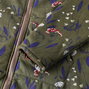 Detailed view of women floral cotton jacket showing olive green fabric and zipper