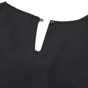 Detailed close-up of the elegant keyhole back neckline with a single button closure