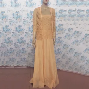 Detailed view of an elegant apricot lace cardigan and chiffon maxi skirt set on a mannequin.