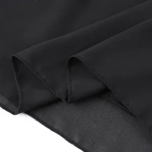 Close-up detail of the black chiffon fabric and precision stitching on a long elegant dress