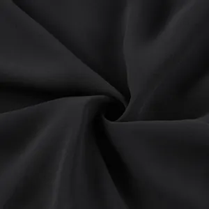 Close-up detail of smooth black chiffon fabric showing elegant drape and texture