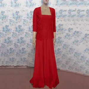 Elegant detail of red lace cardigan paired with a chiffon maxi dress on a display mannequin