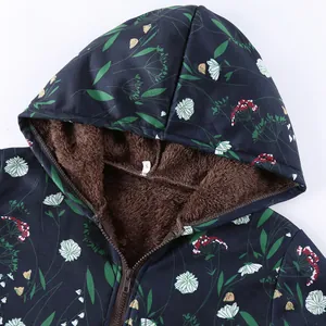Close-up detail of floral hooded jacket with warm brown fleece lining and zipper