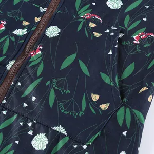 Detailed macro view of navy blue floral print jacket with zipper and side pocket