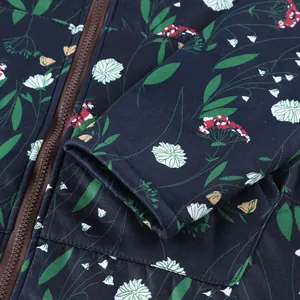 Macro detail view of navy floral print jacket showing sleeve cuff and brown zipper