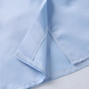 Close-up detail of the premium stitching and finished hem on light blue plus size clothing