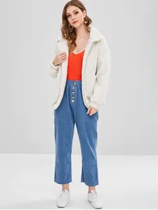Dettaglio completo della giacca in peluche color crema da donna con pantaloni di velluto