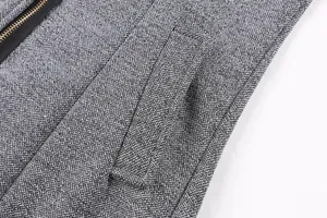 Close-up of grey textured wool fabric and pocket detail on women's winter coat