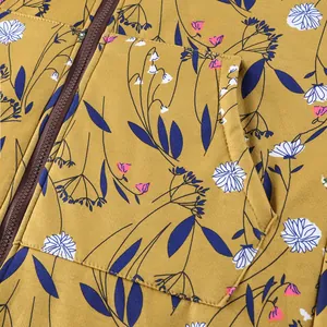 Close-up detail of floral pattern and zipper on mustard yellow thick composite cotton coat
