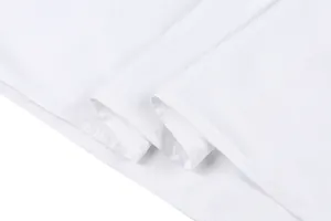 Close-up view of white summer dress hemline showing high-quality stitching details.