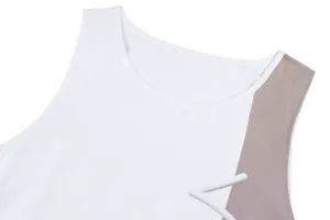 Detailed view of white and tan sleeveless vintage summer dress neckline and stitching.