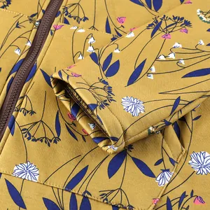 Close-up detail of floral print and zipper on women's long-sleeve hooded padded jacket