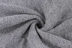 Detailed view of grey textured composite plush fabric showing weave and softness