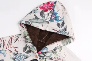 Detail view of floral print hood and thick brown plush lining on winter jacket