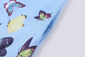 Macro view of blue butterfly print dress fabric highlighting the functional side pocket detail