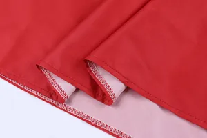 Detailed close-up showing the professional stitching and fabric texture of a red retro summer dress.