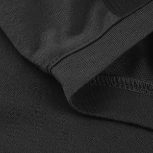 Close-up detail showing high-quality stitching and texture on black sweatshirt fabric