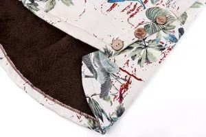 Close-up of women's floral jacket detail showing plush lining and wooden buttons