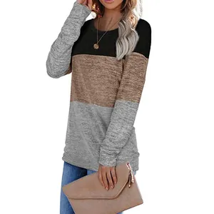 Detailed view of women's long-sleeve sweatshirt with black, brown, and grey color-blocking