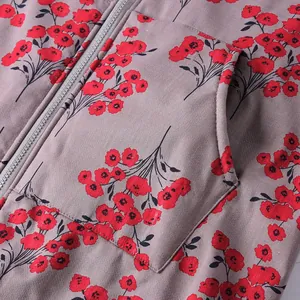 Close-up detail of women's floral cotton jacket featuring zipper and large side pocket.