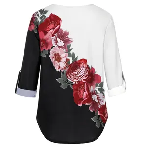 Detail of V-neck blouse with elegant floral print and black-white split design.