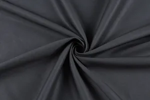 Close-up detail of black vintage dress fabric texture showing fine weave and soft drape