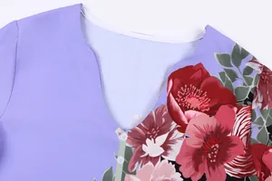 Detailed macro view of the V-neckline and floral print pattern on a lavender summer blouse.