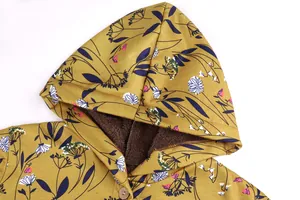Detail view of floral print hood and warm brown fleece lining on winter coat