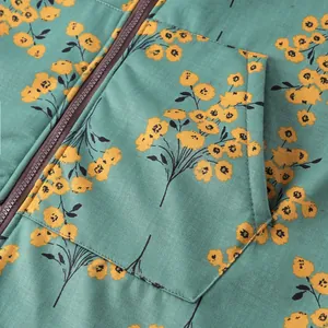 Detail view showing floral print texture and zipper on women's hooded cotton-padded jacket