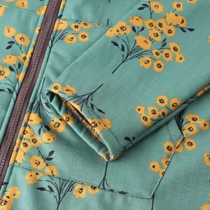 Close-up detail of women's floral print padded jacket with zipper and pocket