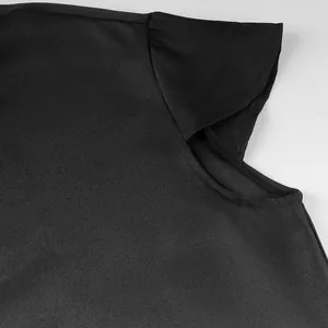 High-quality close-up of a black medieval tunic showing durable fabric texture and sleeve seams